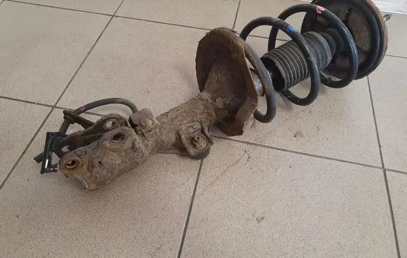 Mitsubishi Lancer VIII Front shock absorber with coil spring