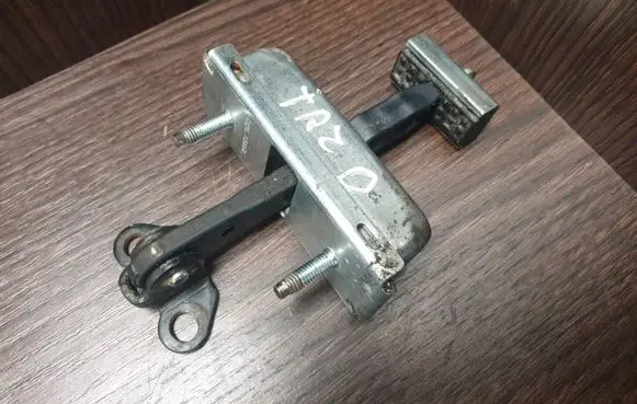 Front door check strap stopper
