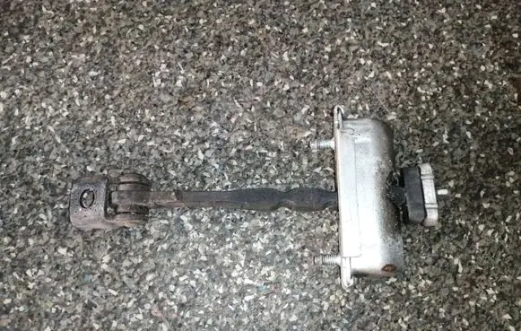 Front door check strap stopper