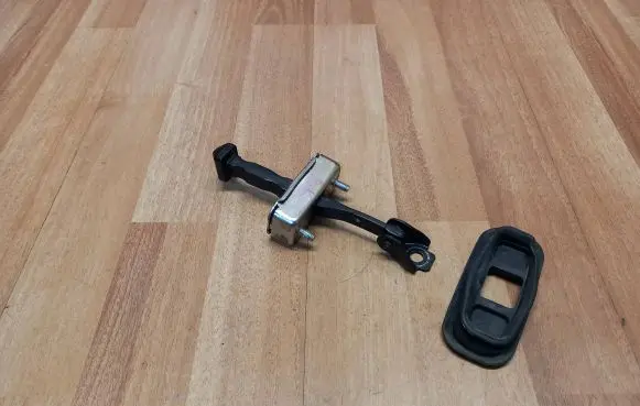 Front door check strap stopper