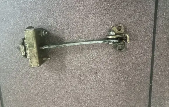 Front door check strap stopper