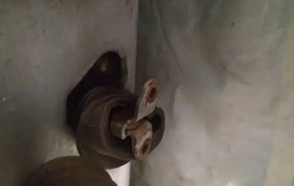 Front door check strap stopper