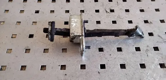 Front door check strap stopper
