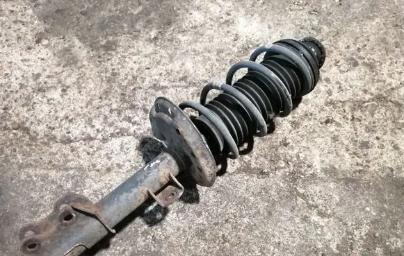 Opel Corsa D Front shock absorber with coil spring 13214353