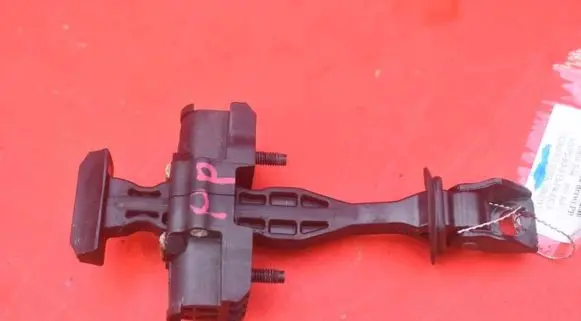 Front door check strap stopper