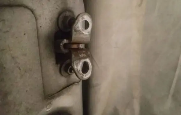Front door check strap stopper