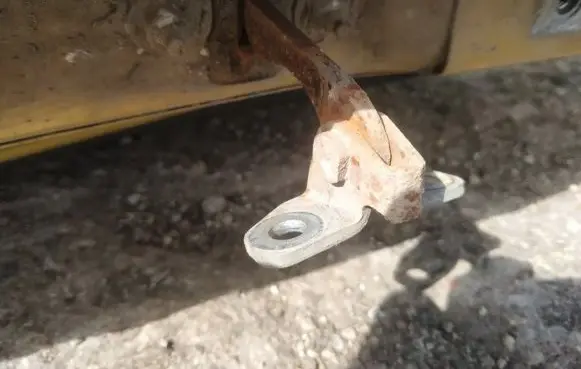 Front door check strap stopper