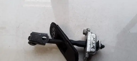 Front door check strap stopper