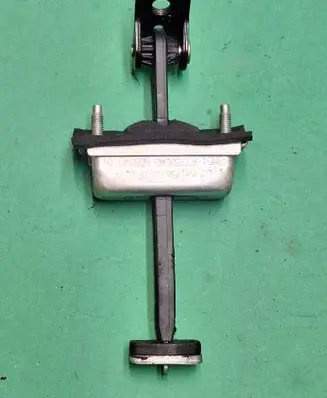 Front door check strap stopper
