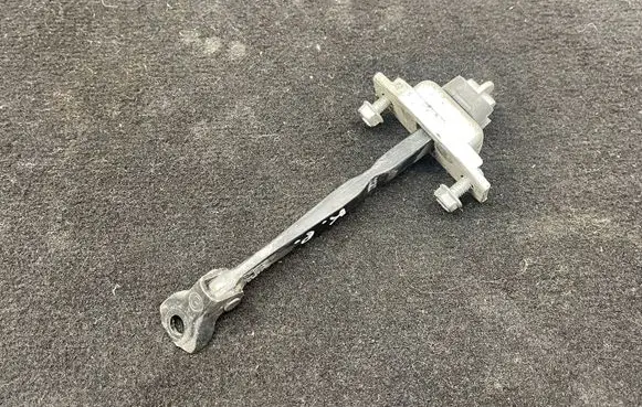 Front door check strap stopper