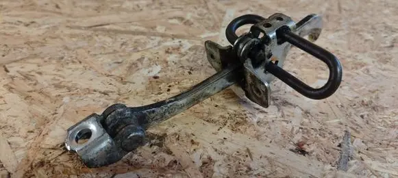 Front door check strap stopper
