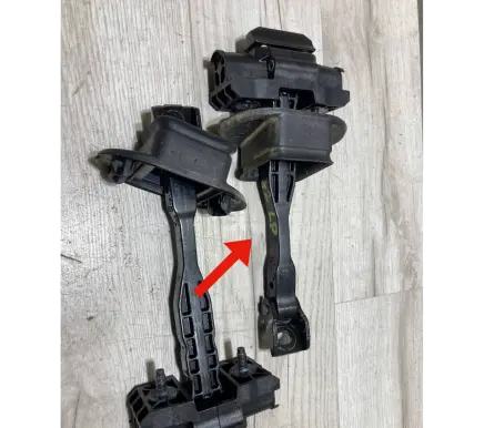 Front door check strap stopper