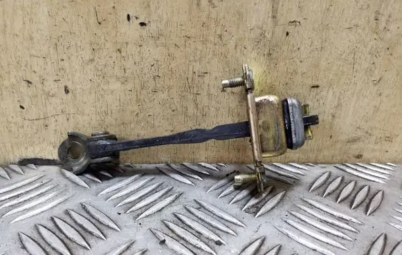 Front door check strap stopper