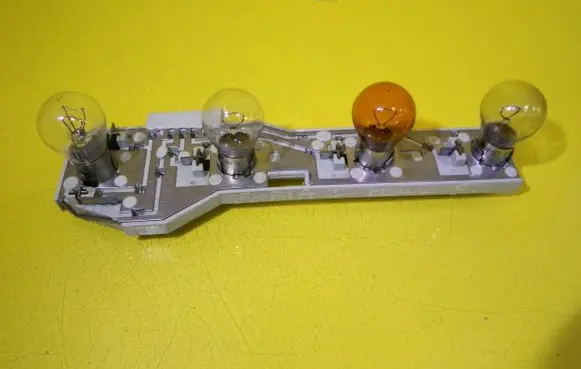 Tail light bulb cover holder