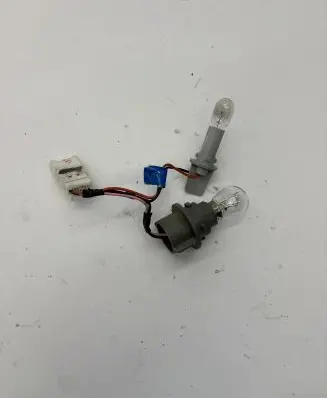 Tail light bulb cover holder
