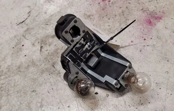 Tail light bulb cover holder