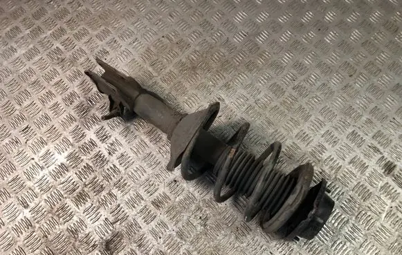 Subaru Impreza I Front shock absorber with coil spring