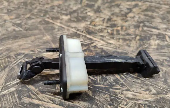 Front door check strap stopper