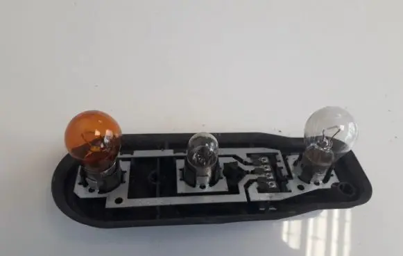 Tail light bulb cover holder