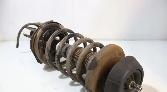 Suzuki Swift I Front shock absorber with coil spring