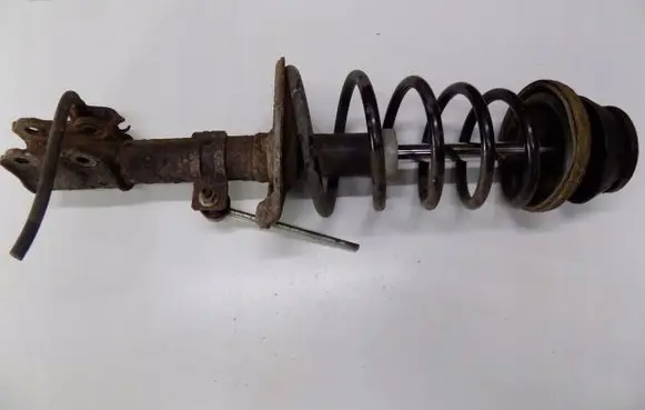 Suzuki Swift I Front shock absorber with coil spring