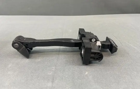 Front door check strap stopper