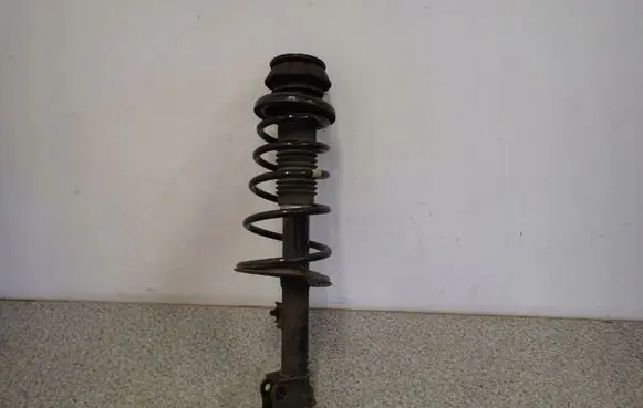 Suzuki Swift I Front shock absorber with coil spring