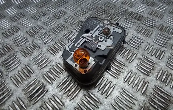 Tail light bulb cover holder