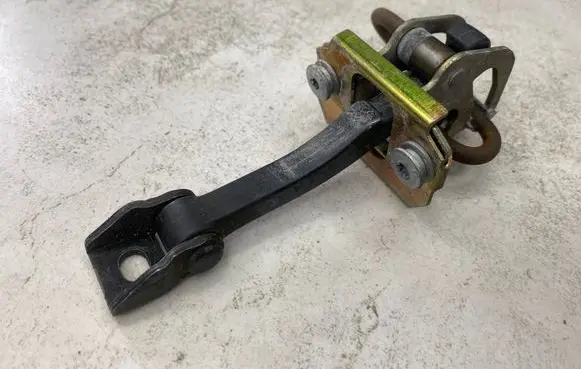 Front door check strap stopper