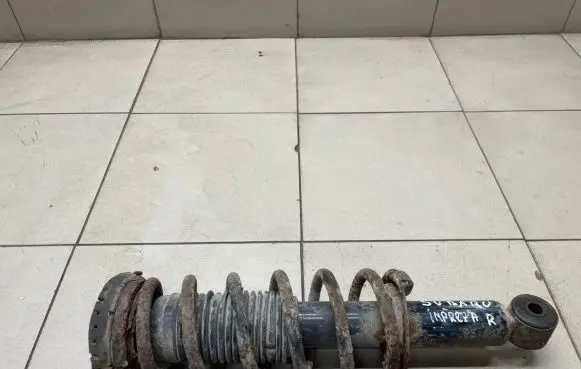 Subaru Impreza I Front shock absorber with coil spring