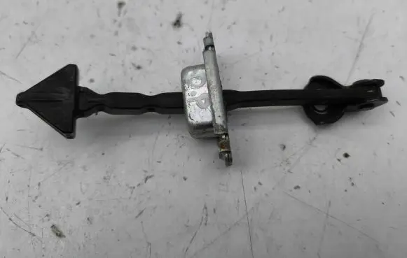 Front door check strap stopper