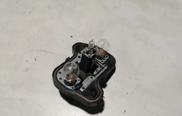 Tail light bulb cover holder