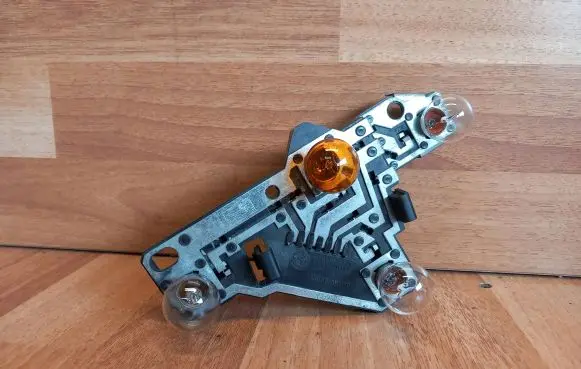 Tail light bulb cover holder