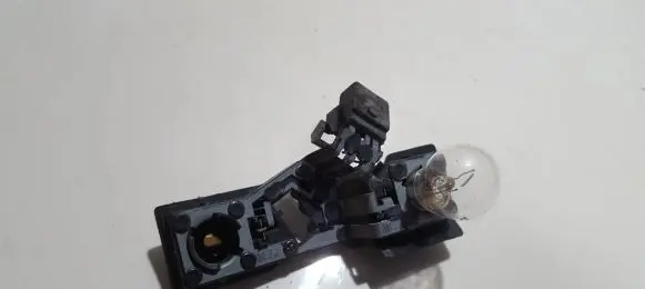 Tail light bulb cover holder