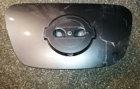 Nissan Leaf I (ZE0) Electric car charge socket cover 657133NL0C