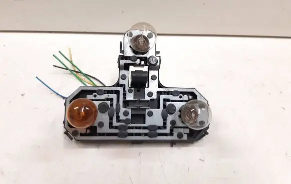 Tail light bulb cover holder