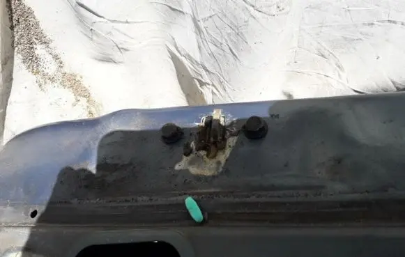 Front door check strap stopper