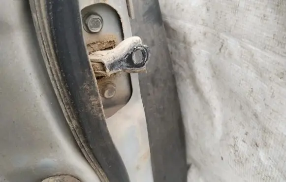 Front door check strap stopper