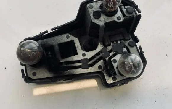 Tail light bulb cover holder
