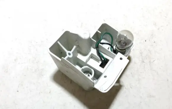 Tail light bulb cover holder