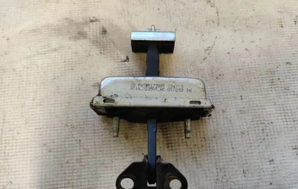 Front door check strap stopper