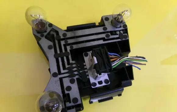 Tail light bulb cover holder