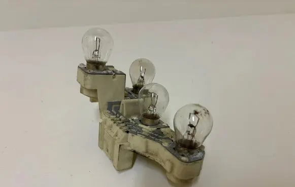 Tail light bulb cover holder