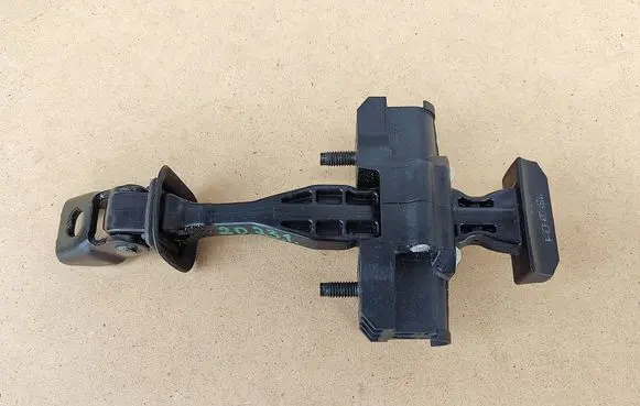 Front door check strap stopper
