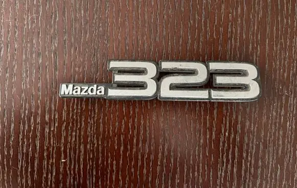 Mazda 323 Manufacturers badge/model letters 