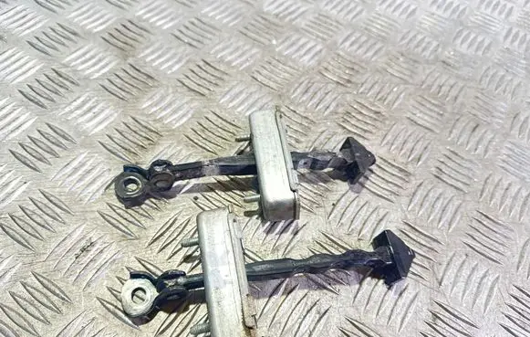 Front door check strap stopper