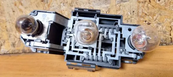 Tail light bulb cover holder
