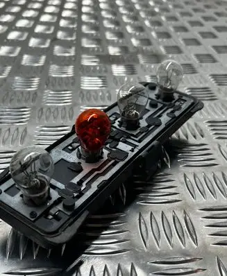 Tail light bulb cover holder