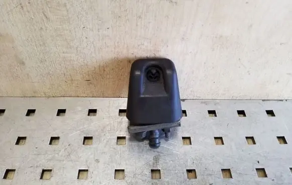 Mitsubishi Pajero Sport I Headlight washer spray nozzle