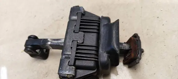 Front door check strap stopper